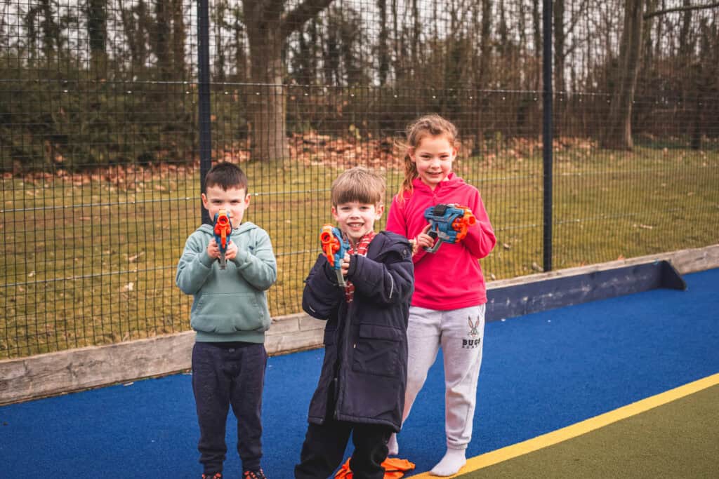 Three kids holding up their Nerf Guns at our February Half Term Camp