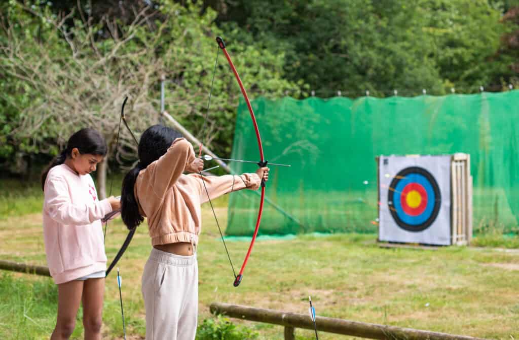 Children taking part in an archery activity at an Educamps Adventures 3 Day Summer Camp