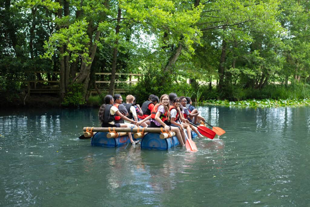 Children having fun on a raft building activity on a lake on an Educamps Adventures 3 Day Summer Camp (Children aged between 8-11 years)
