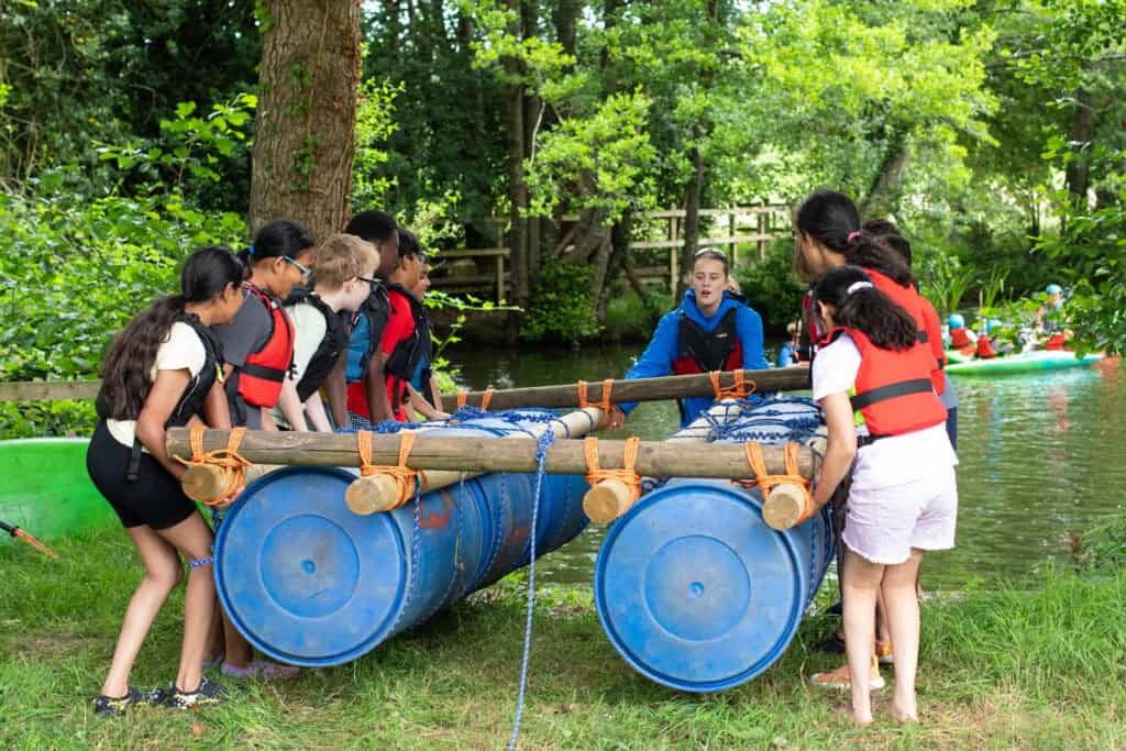 Children taking part in a raft building activity at an Educamps Adventures 3 Day Summer Camp