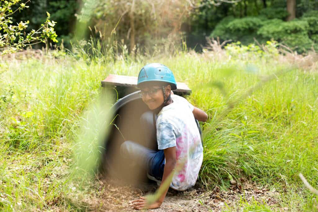 A child taking part in a tunnelling activity at an Educamps Adventures 3 Day Summer Camp