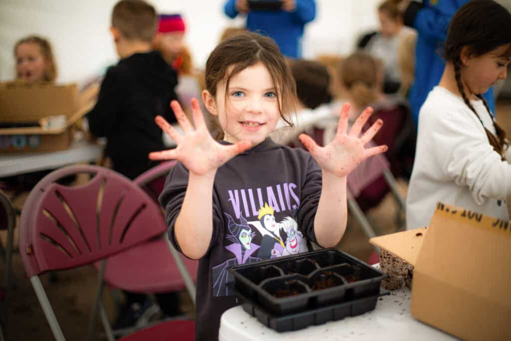 Kids enjoying hands-on gardening activities during Educamps Inset Day at Sopley Primary School