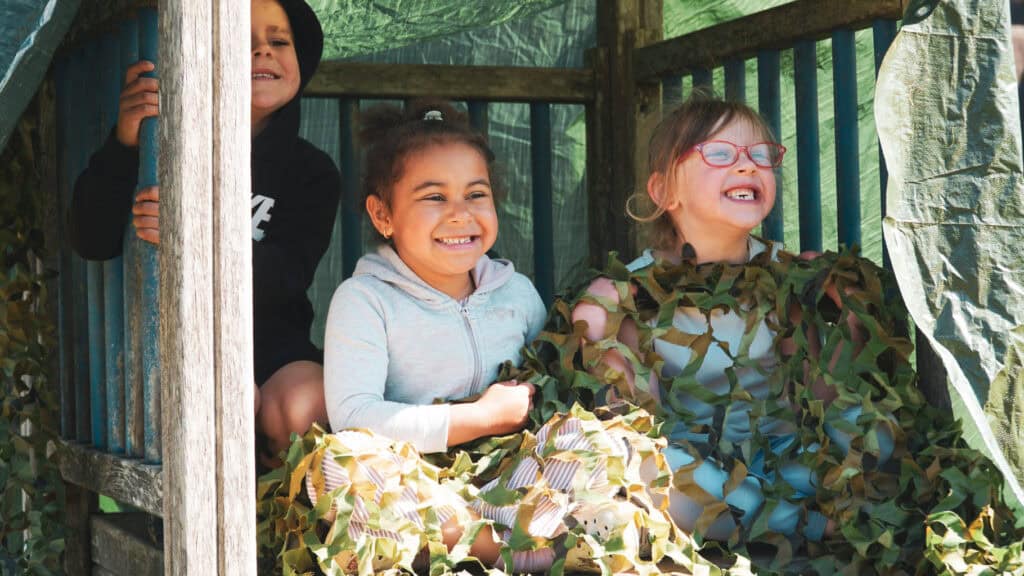 Kids playing outdoor camouflage and nature games during Educamps Inset Day Camp
