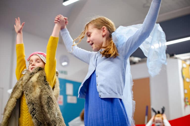 Kids Enjoying performing a play in-front of an audience as part of their performing arts club