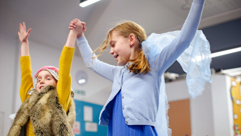 Kids Enjoying performing a play in-front of an audience as part of their performing arts club