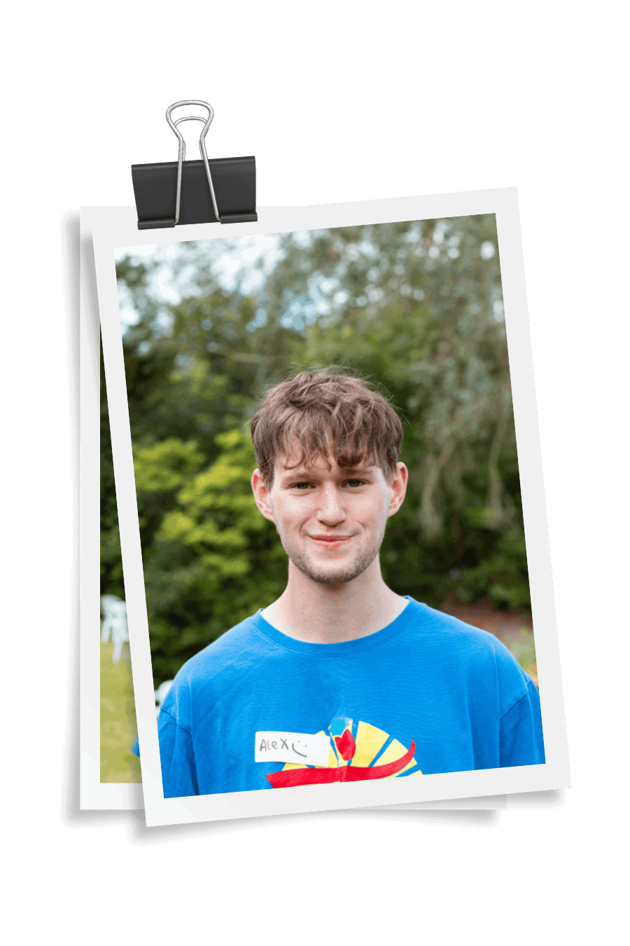 Holiday club leader teaching bushcraft skills to children outdoors